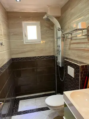 a bathroom with a shower and a toilet and a sink at Meknes Apartment Oudi in Meknès