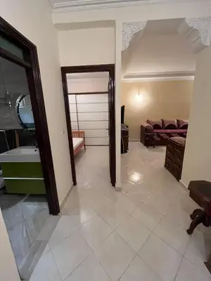 a living room with a tub and a bedroom at Meknes Apartment Oudi in Meknès