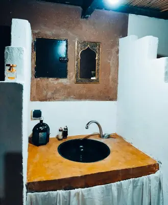 a bathroom with a sink and a mirror at Silent Camp in Mhamid