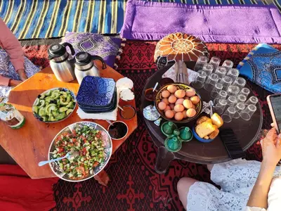 a table with food and drinks on top at Silent Camp in Mhamid