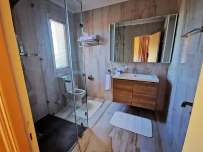 a bathroom with a shower and a sink and a toilet at Domaine Lamrah in Marrakech