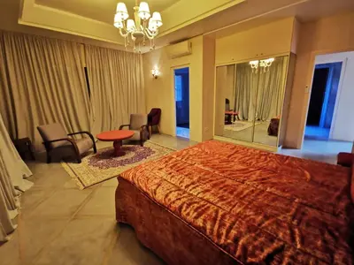 a bedroom with a large bed and a large mirror at Domaine Lamrah in Marrakech