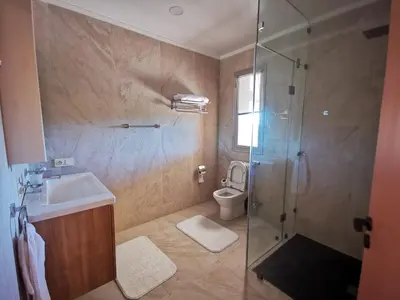 a bathroom with a shower and a sink and a toilet at Domaine Lamrah in Marrakech