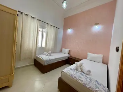 a bedroom with two beds and a window at appartement meublee a louer sur Fes in Fès