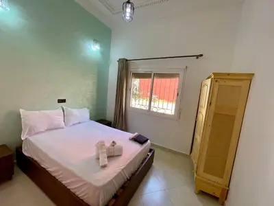 a bedroom with a bed with two boxes on it at appartement meublee a louer sur Fes in Fès