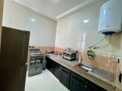 a kitchen with a sink and a stove at appartement meublee a louer sur Fes in Fès
