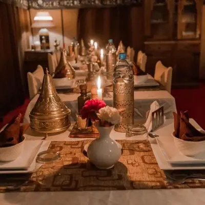 a long table with candles and vases on it at Sahara Family Luxury Camp in Merzouga