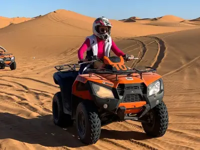 a person on an atv in the desert at Sahara Family Luxury Camp in Merzouga