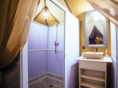 a bathroom with a shower and a sink at Sahara Family Luxury Camp in Merzouga