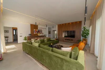 a large living room with green couches and a television at Villa Marrakech vue atlas in Marrakech
