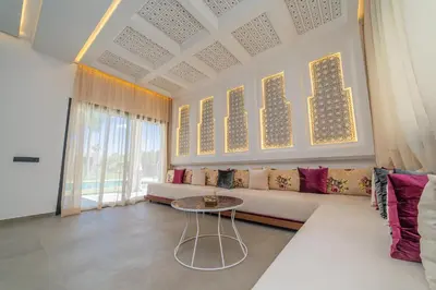 a living room with a couch and a table at Villa Marrakech vue atlas in Marrakech