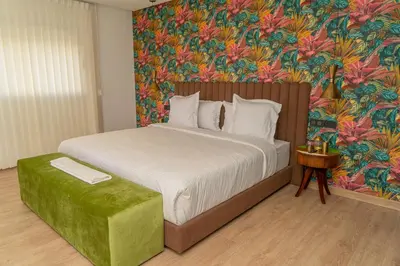 a bedroom with a large bed with a floral wallpaper at Villa Marrakech vue atlas in Marrakech