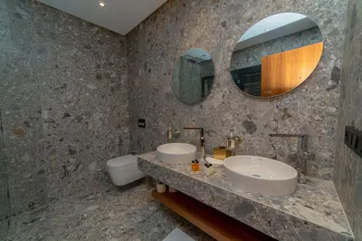 a bathroom with two sinks and a mirror at Villa Marrakech vue atlas in Marrakech