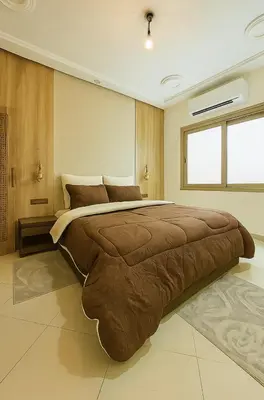 a bedroom with a large bed in a room at Appartement avec un style de chalet in Azrou