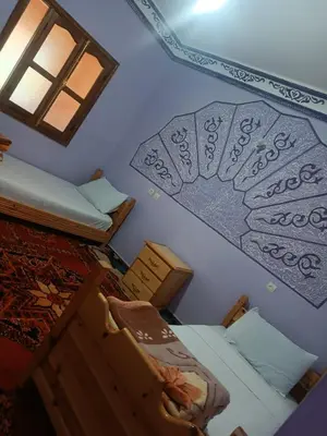 a room with two bunk beds and a window at Ait Ayoub Voyages in Azilal