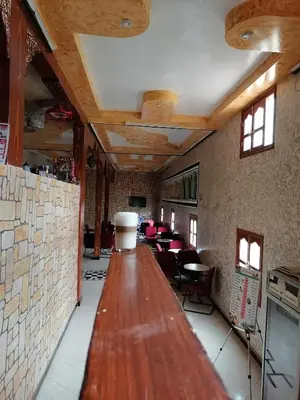 a long wooden table in a room with tables at Ait Ayoub Voyages in Azilal