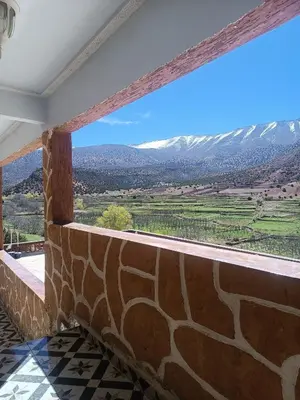 a view from the balcony of a house with a stone wall at Ait Ayoub Voyages in Azilal