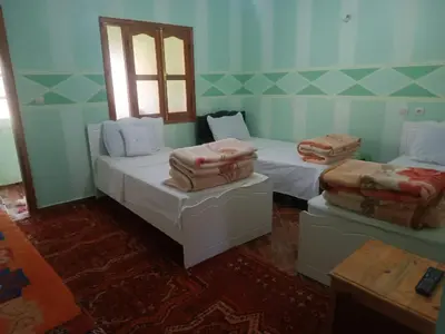 a room with two beds and a window at Ait Ayoub Voyages in Azilal