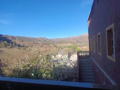 a view from a balcony of a building with mountains in the background at Ait Ayoub Voyages in Azilal