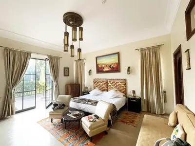a bedroom with a bed and a living room at La Kasbah Aalma D'or in Najem