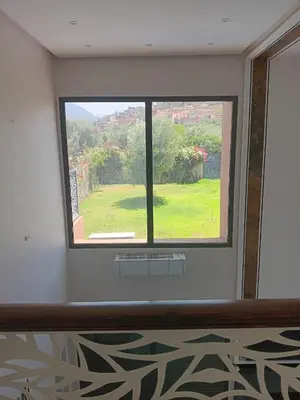 a room with a window with a view of a yard at Villa Jamel Marrakech Zac in Marrakech