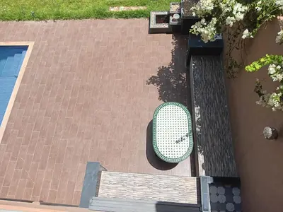 a green bench sitting on the side of a building at Villa Jamel Marrakech Zac in Marrakech