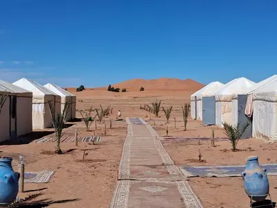 a desert with some blue vases in the dirt at Unforgettable Nights in Merzouga in Merzouga