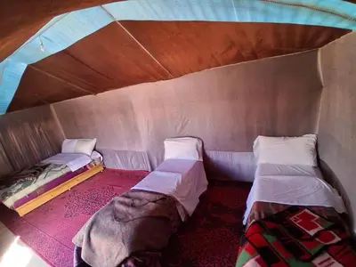 a room with two beds in a tent at Unforgettable Nights in Merzouga in Merzouga
