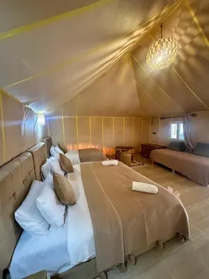 a bedroom with a large bed in a tent at Magnificent Luxury Camp in Merzouga