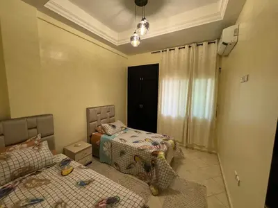 a bedroom with two beds and a couch at Downtown Fez Delight Apartment in Fès