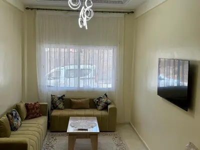 a living room with a couch and a window at Downtown Fez Delight Apartment in Fès