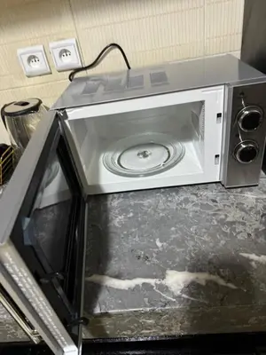 a microwave oven on a counter with its door open at Downtown Fez Delight Apartment in Fès