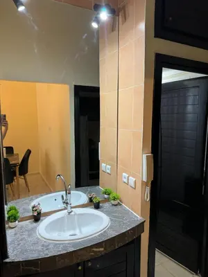 a bathroom with a sink and a mirror at Downtown Fez Delight Apartment in Fès