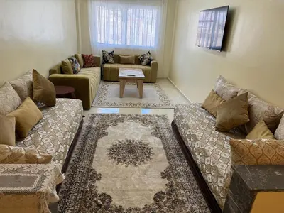 a living room with two couches and a table at Downtown Fez Delight Apartment in Fès