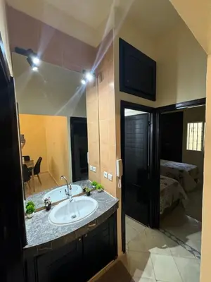 a bathroom with a sink and a mirror at Downtown Fez Delight Apartment in Fès