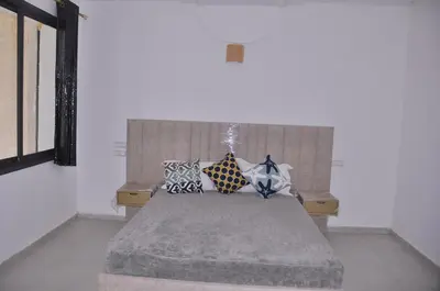 a bedroom with a bed with pillows on it at Amira Suite Double with Bathroom in Fès