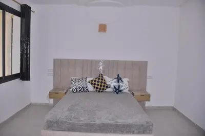 a bedroom with a bed with pillows on it at Amira Suite Double with Bathroom in Fès