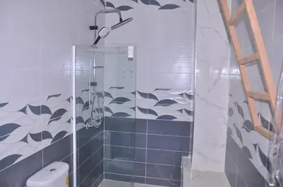 a shower with a glass door in a bathroom at Amira Suite Double with Bathroom in Fès