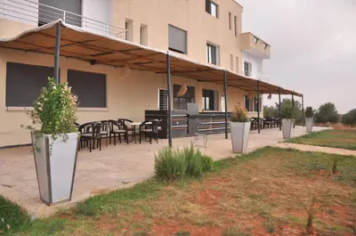 a patio with tables and chairs in front of a building at Amira Suite Double with Bathroom in Fès