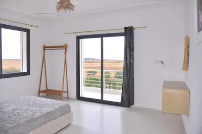 a bedroom with a bed and a large window at Amira Suite Double with Bathroom in Fès