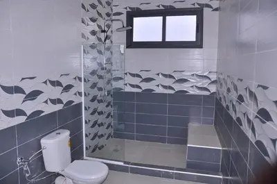 a bathroom with a toilet and a window at Amira Suite Double with Bathroom in Fès