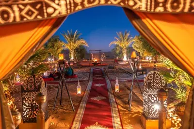 a view of a tent with lights in the desert at khayma Camp And Actevities in Merzouga