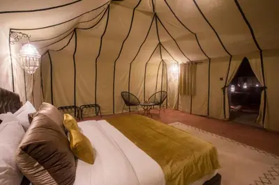 a bedroom with a bed in a tent at khayma Camp And Actevities in Merzouga