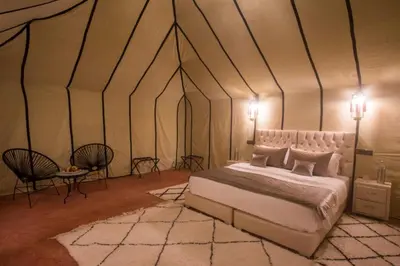 a bedroom with a bed in a tent at khayma Camp And Actevities in Merzouga