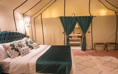 a bedroom with a bed in a tent at khayma Camp And Actevities in Merzouga
