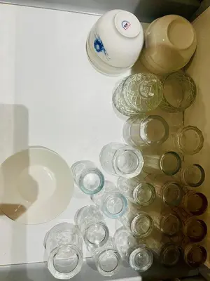 a pile of glass plates and bowls on a shelf at Villa de la famille, with Private pool in Marrakech