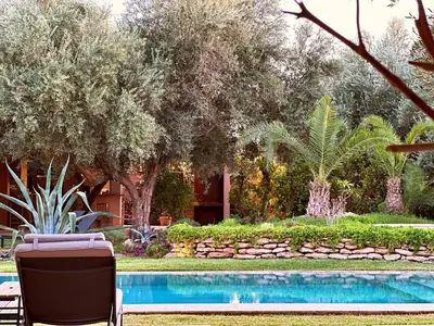 a resort with a swimming pool and trees at Jardin Sakina - Séjour paisible avec soins bien-être, à 35 minutes de Marrakech in Marrakech