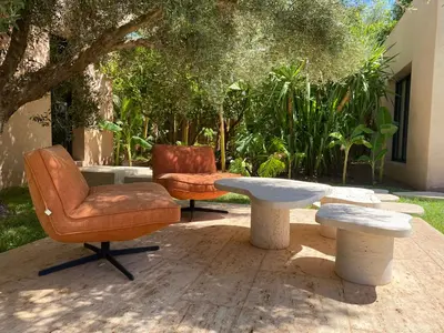 a patio with two chairs and a table and a chair and a table at Jardin Sakina - Séjour paisible avec soins bien-être, à 35 minutes de Marrakech in Marrakech