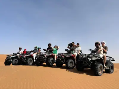 a group of people riding atvs in the desert at Touareg Desert Camp Erg Chigaga in El Gouera