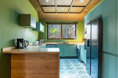 a kitchen with green walls and a refrigerator at Villa a Marrakech with private pool in Marrakech